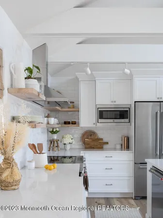 a kitchen with refrigerator and stove