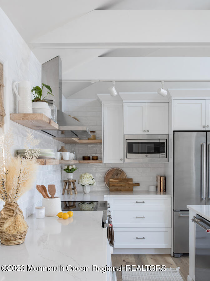 76 Bridge Avenue, Unit REAR COTTAGE Point Pleasant Beach, NJ 08742 - Photo 3 of 13 a kitchen with refrigerator and stove