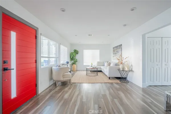 a living room with furniture and large windows