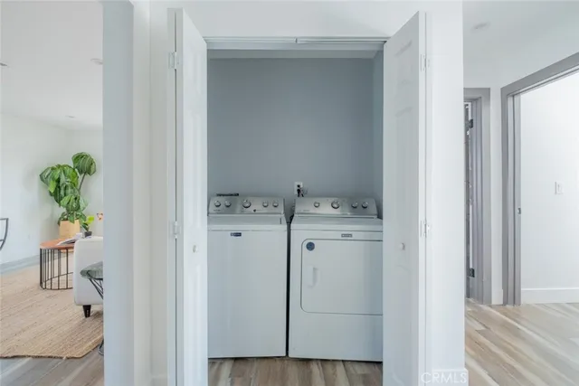 a utility room with cabinets washer and dryer