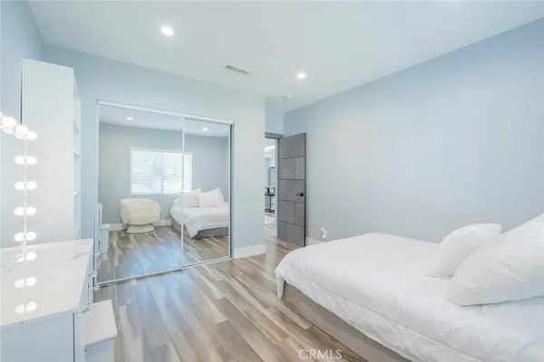 a bedroom with a bed and a mirror