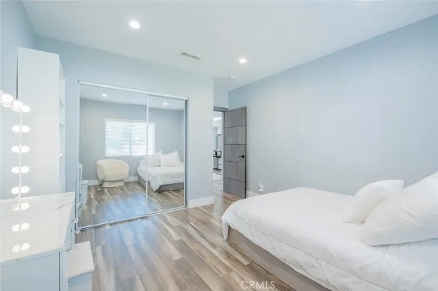 a bedroom with a bed and a mirror