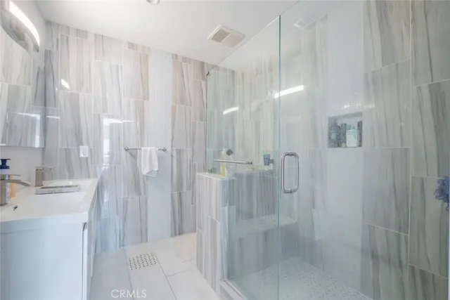 a bathroom with a shower and a sink