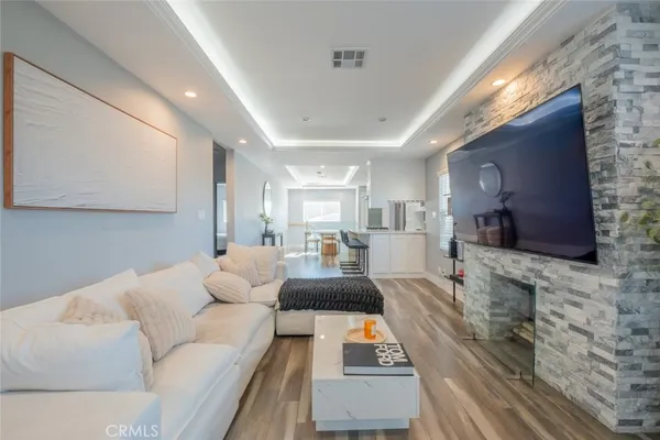 a living room with furniture a flat screen tv and a fireplace