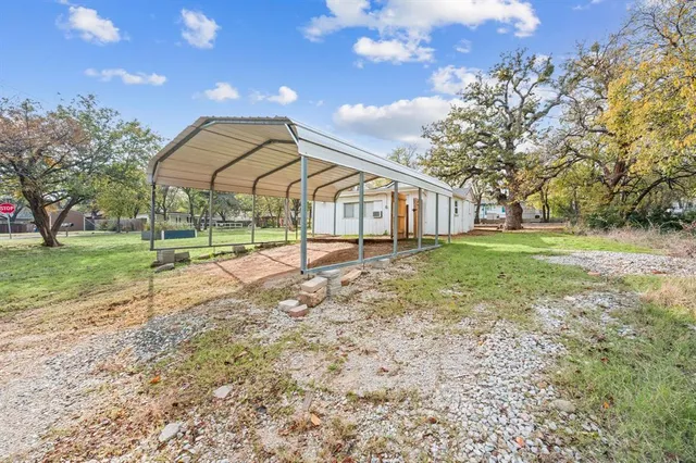 a view of a house with a yard and a garden