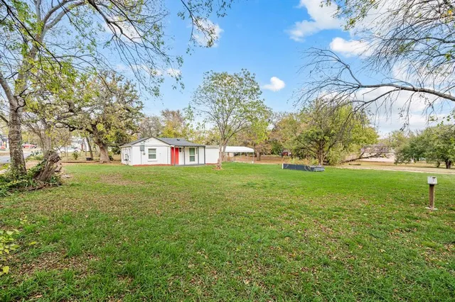 a view of yard with swimming pool and green space