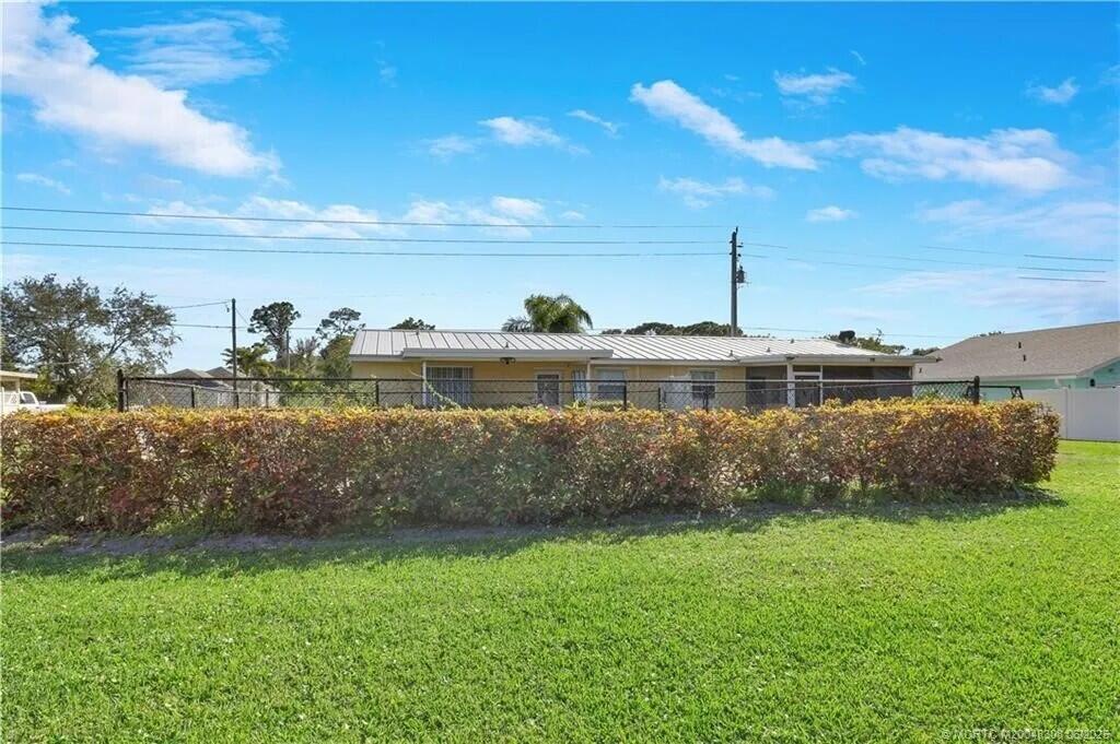 2777 Southeast Normand Street Stuart, FL 34997 - Photo 14 of 14 a view of a lake with a yard