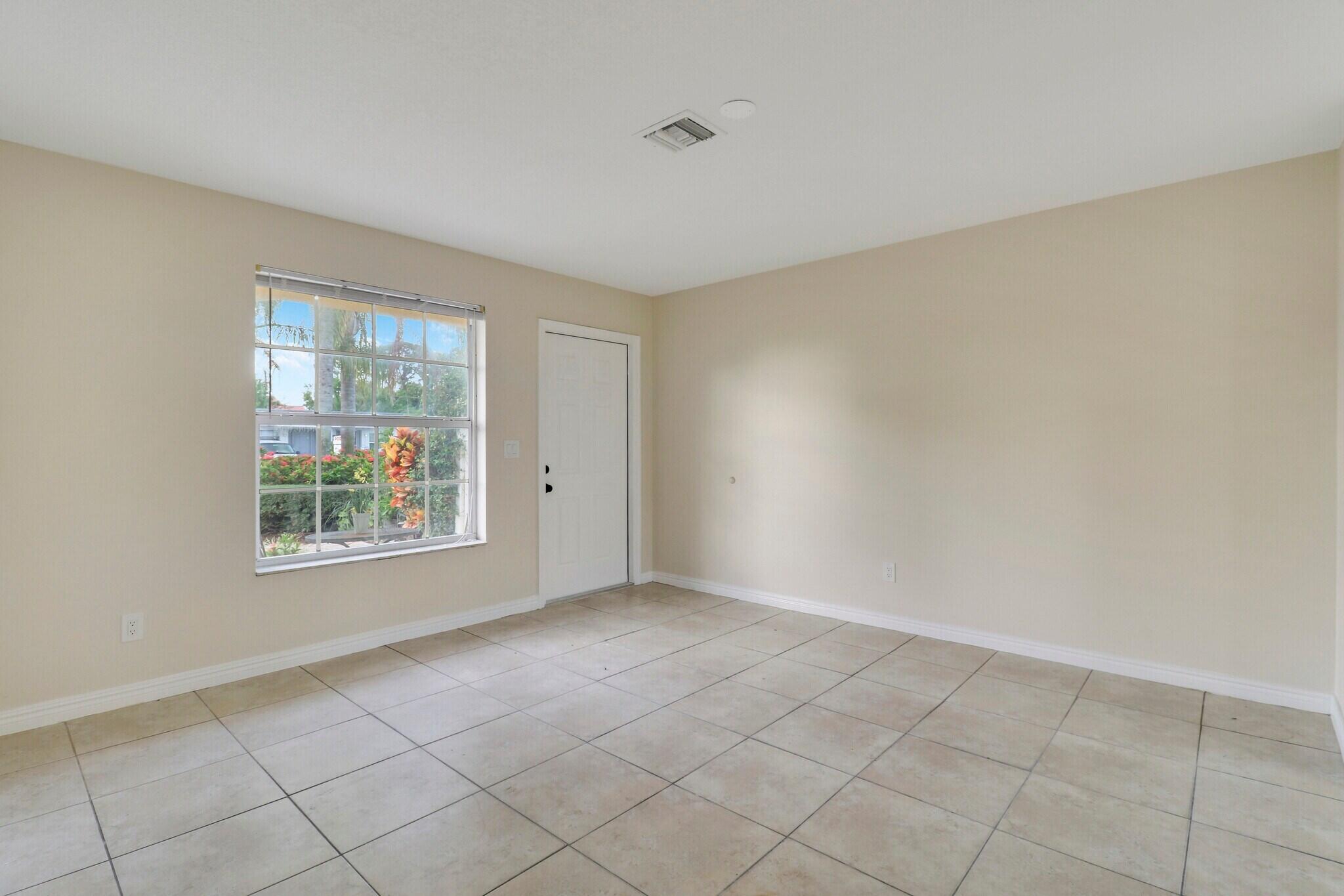 2777 Southeast Normand Street Stuart, FL 34997 - Photo 7 of 14 an empty room with windows