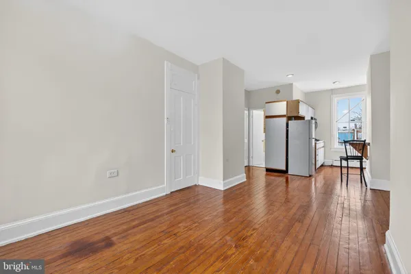 a view of empty room with wooden floor