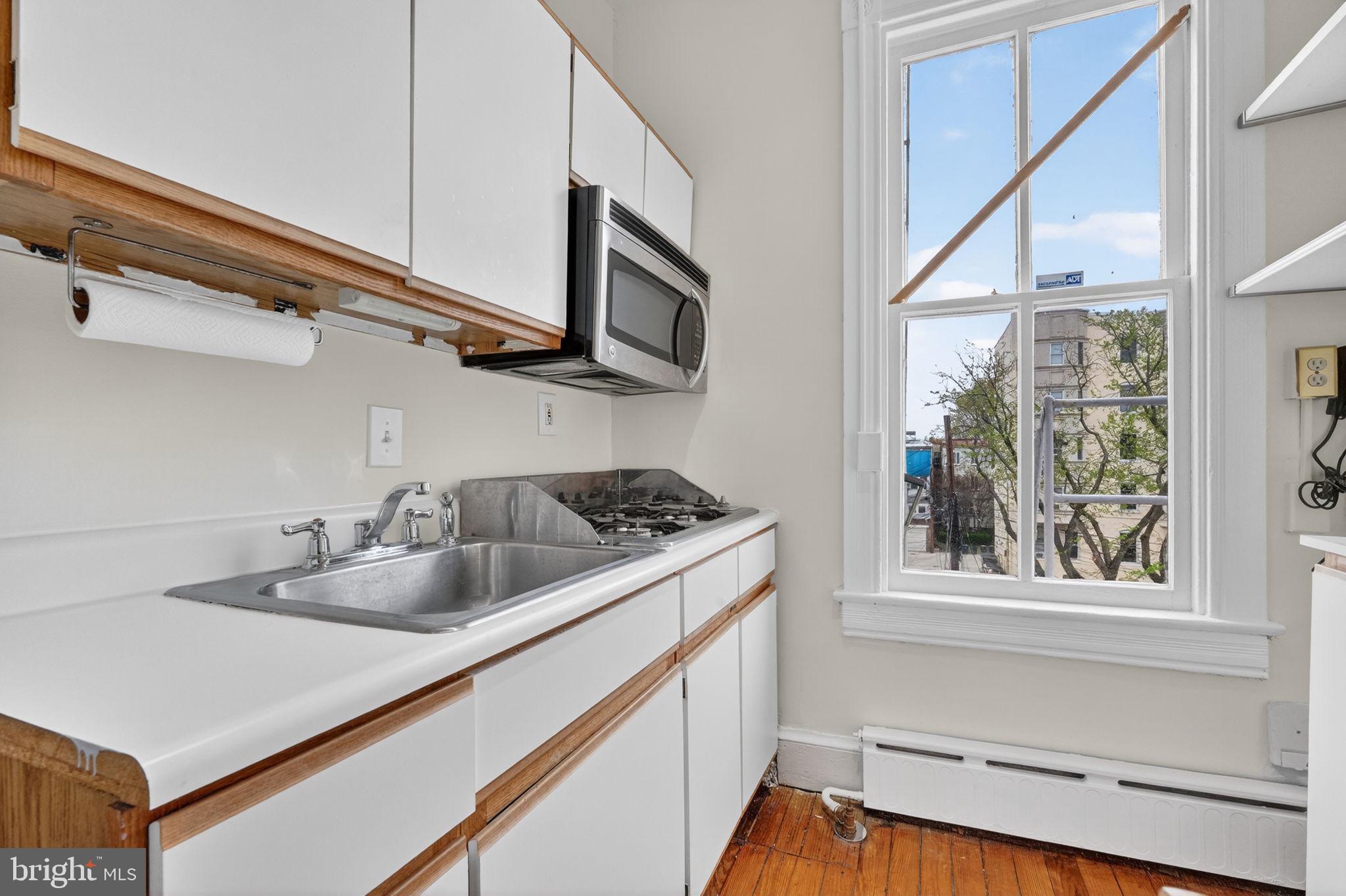 15 3rd Street Northeast, Unit 5 Washington, DC 20002 - Photo 14 of 24 a kitchen with stainless steel appliances granite countertop a sink and a stove