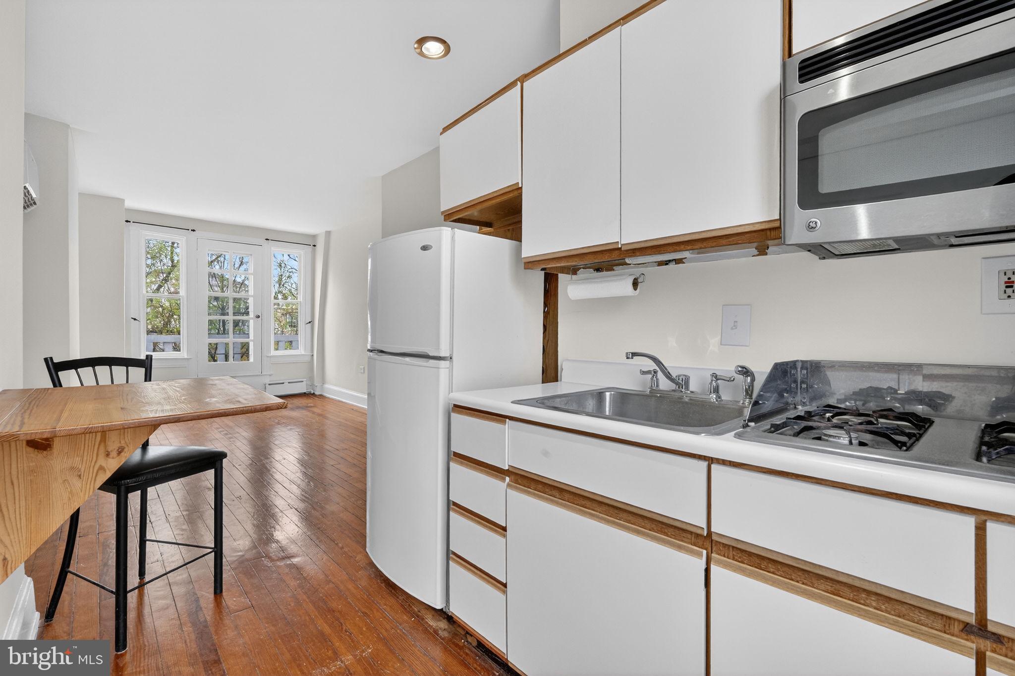 15 3rd Street Northeast, Unit 5 Washington, DC 20002 - Photo 15 of 24 a kitchen with stainless steel appliances granite countertop a sink stove and refrigerator