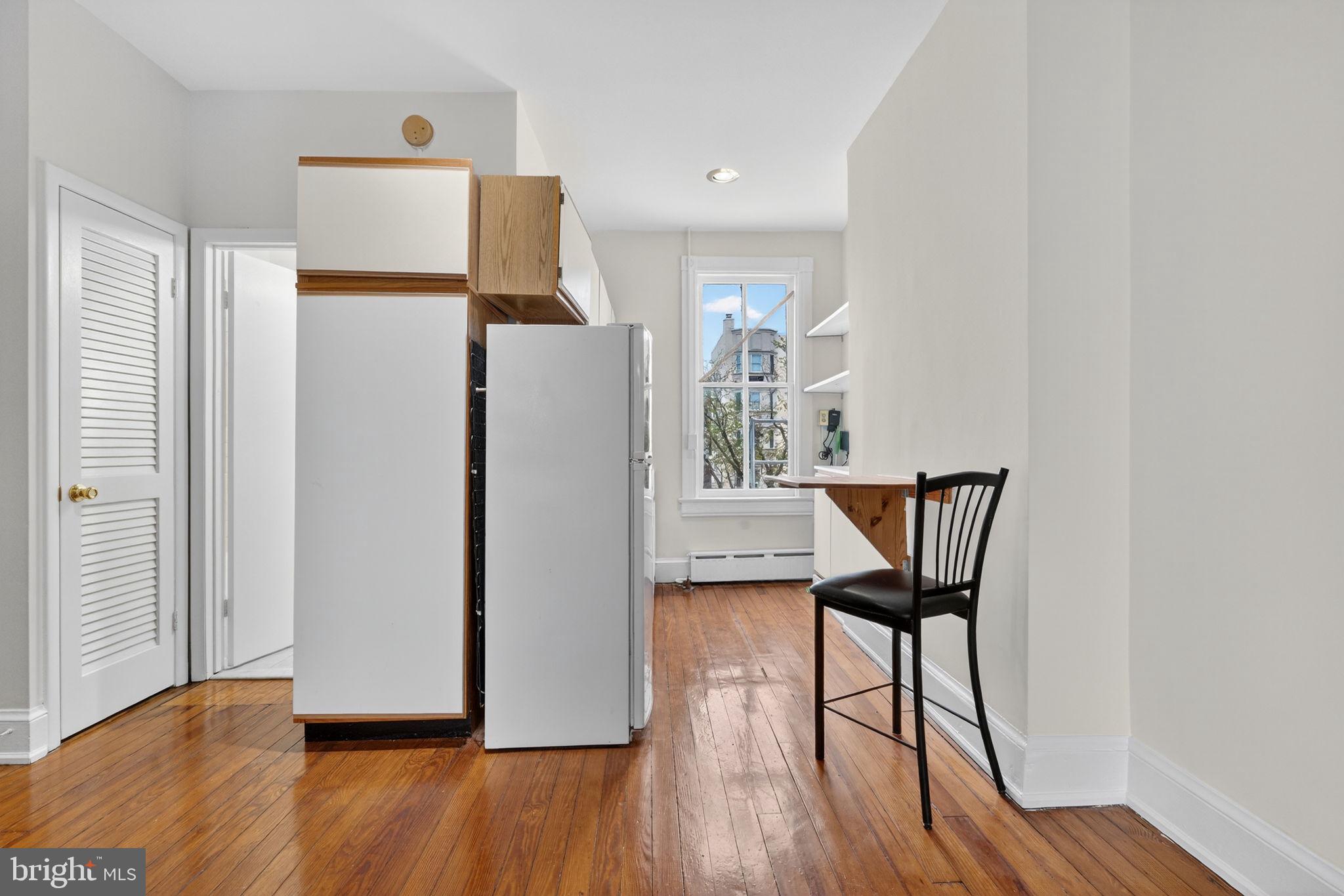 15 3rd Street Northeast, Unit 5 Washington, DC 20002 - Photo 17 of 24 a view of a hallway with wooden floor and a refrigerator