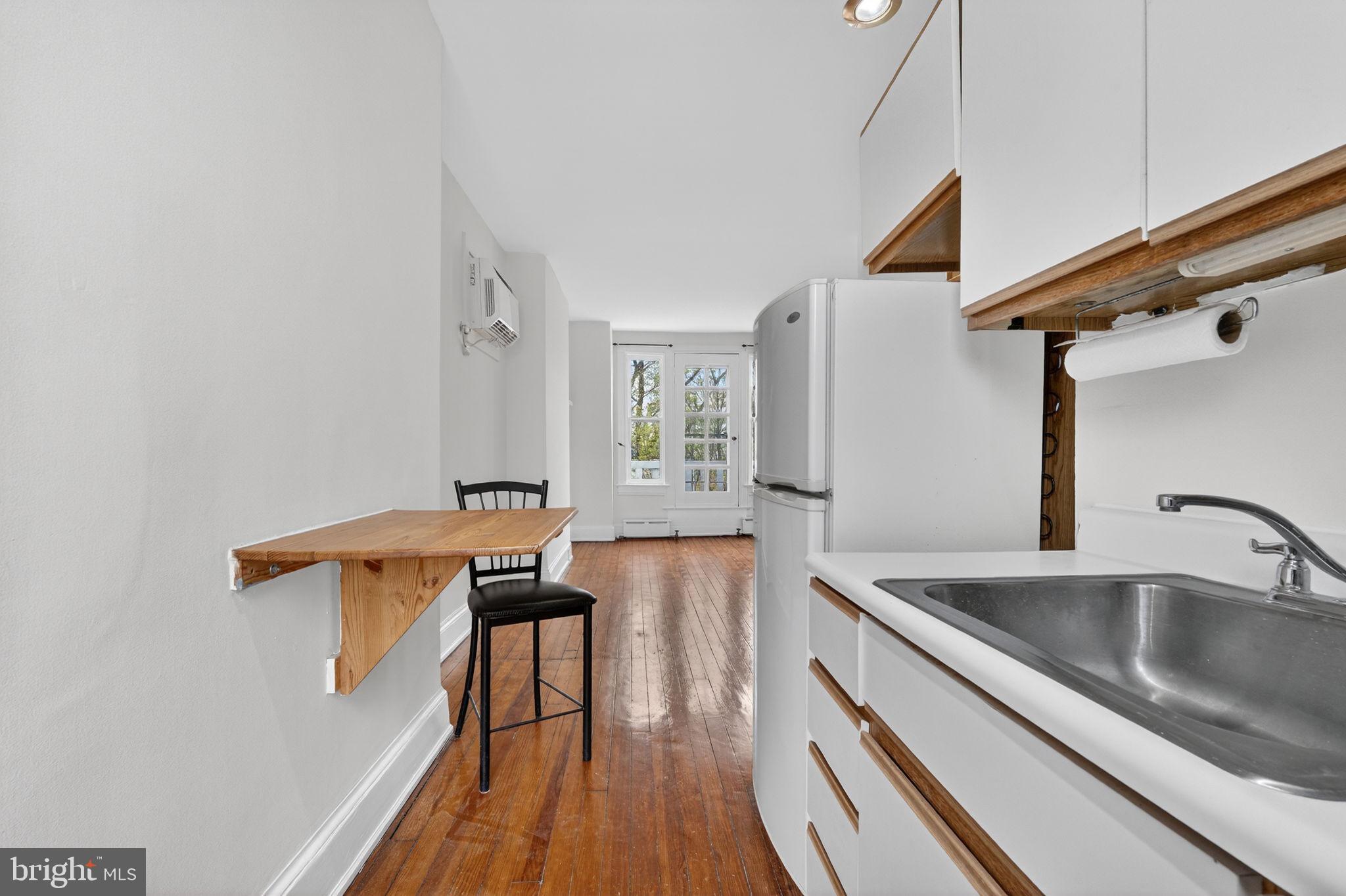 15 3rd Street Northeast, Unit 5 Washington, DC 20002 - Photo 18 of 24 a view of a kitchen with a sink and wooden floor
