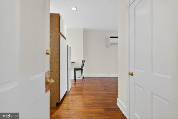 a view of a hallway with wooden floor and staircase