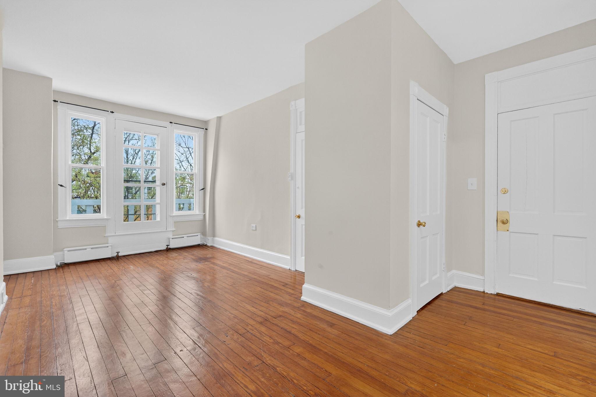 15 3rd Street Northeast, Unit 5 Washington, DC 20002 - Photo 8 of 24 a view of an empty room with wooden floor and a window