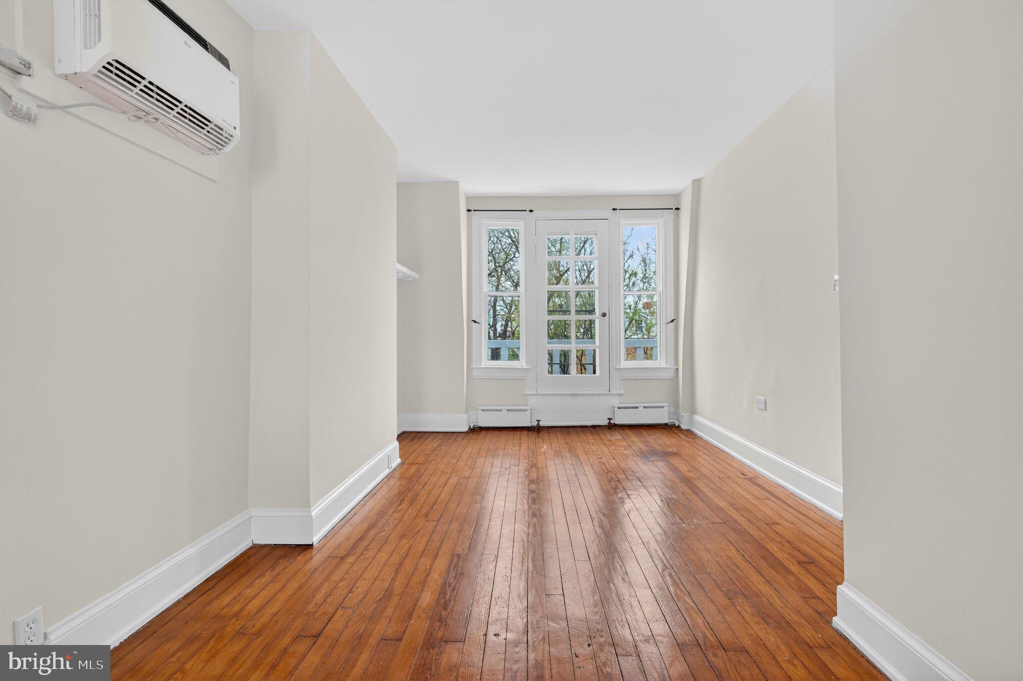 15 3rd Street Northeast, Unit 5 Washington, DC 20002 - Photo 9 of 24 an empty room with wooden floor and windows