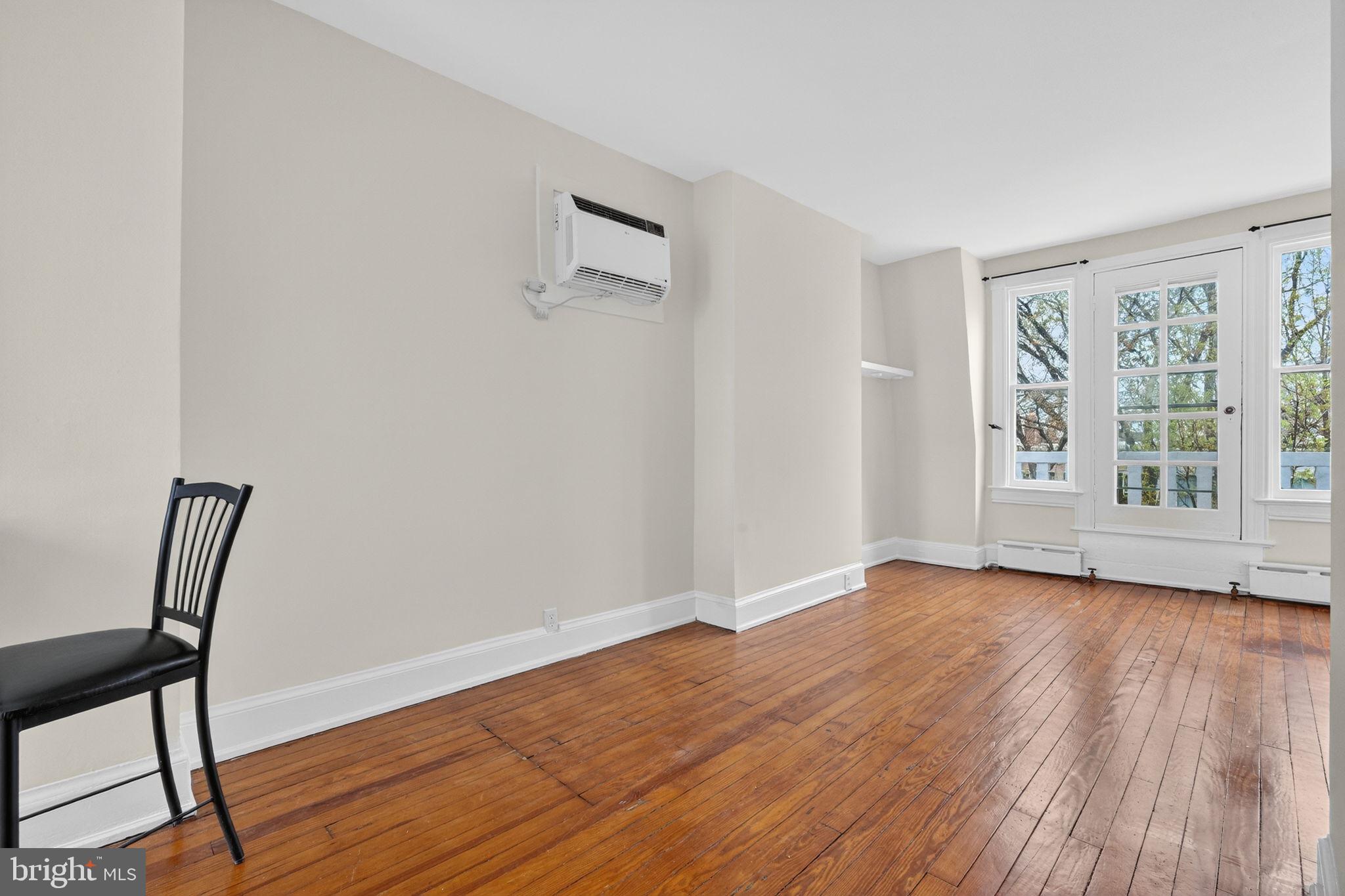 15 3rd Street Northeast, Unit 5 Washington, DC 20002 - Photo 10 of 24 a view of an empty room with wooden floor and a window