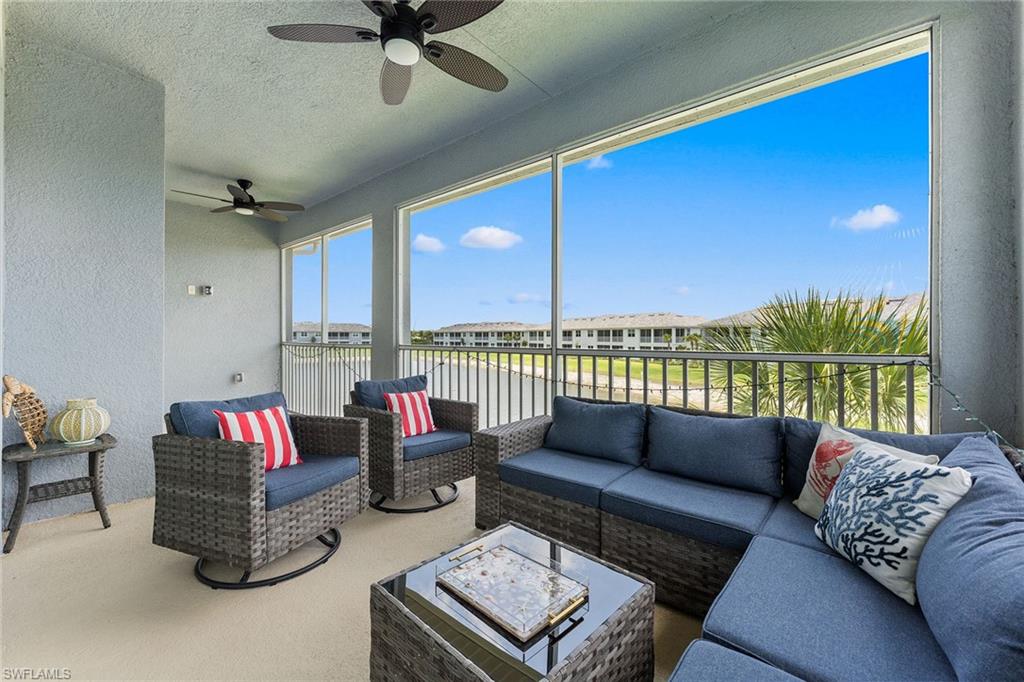 2609 Seychelles Circle, Unit 1608 Naples, FL 34112 - Photo 27 of 35 a living room with furniture and a floor to ceiling window