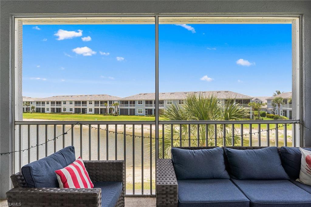 2609 Seychelles Circle, Unit 1608 Naples, FL 34112 - Photo 31 of 35 a living room with furniture and a floor to ceiling window