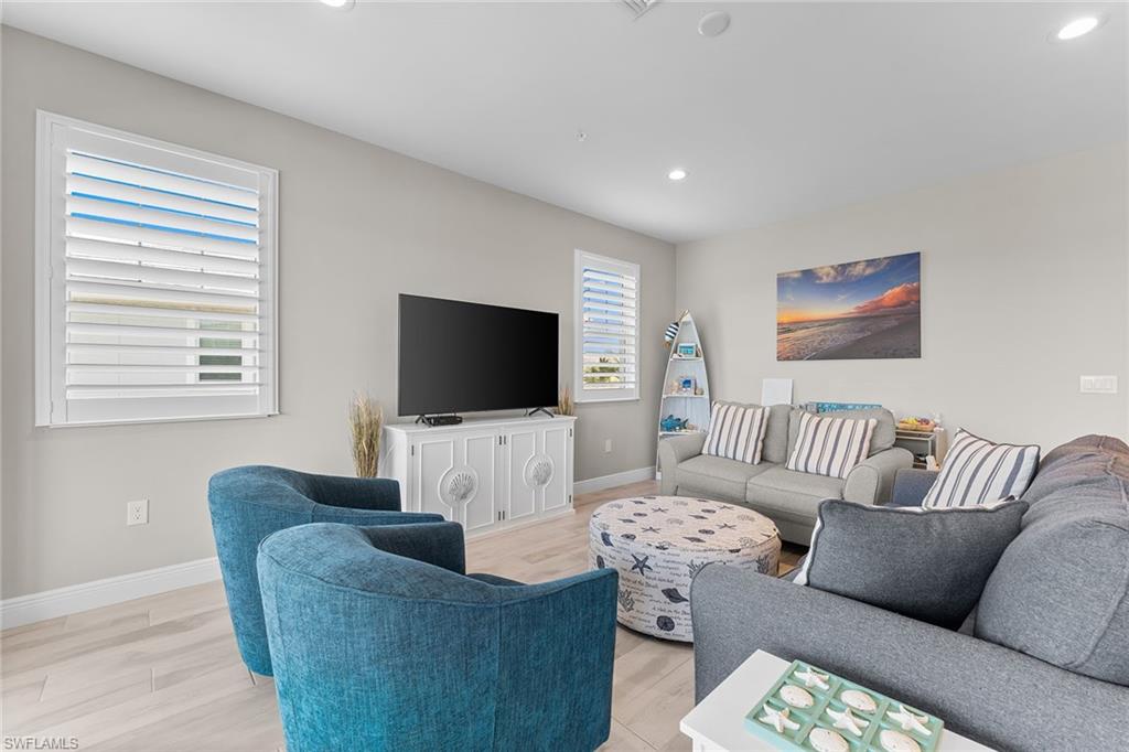 2609 Seychelles Circle, Unit 1608 Naples, FL 34112 - Photo 4 of 35 a living room with furniture and a flat screen tv