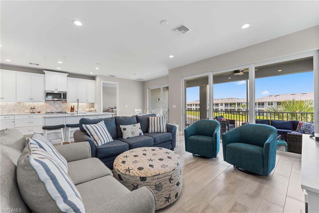 2609 Seychelles Circle, Unit 1608 Naples, FL 34112 - Photo 6 of 35 a living room with furniture and a large window