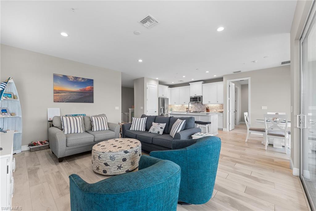 2609 Seychelles Circle, Unit 1608 Naples, FL 34112 - Photo 7 of 35 a living room with furniture and a wooden floor