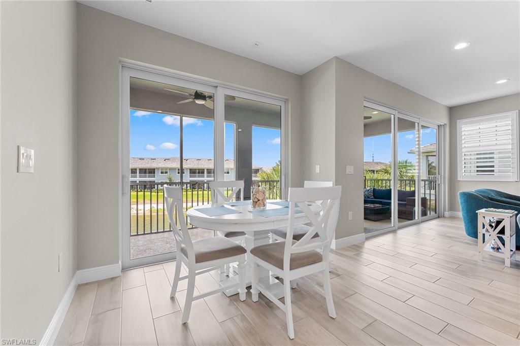 2609 Seychelles Circle, Unit 1608 Naples, FL 34112 - Photo 9 of 35 a dining room with wooden floor and glass door