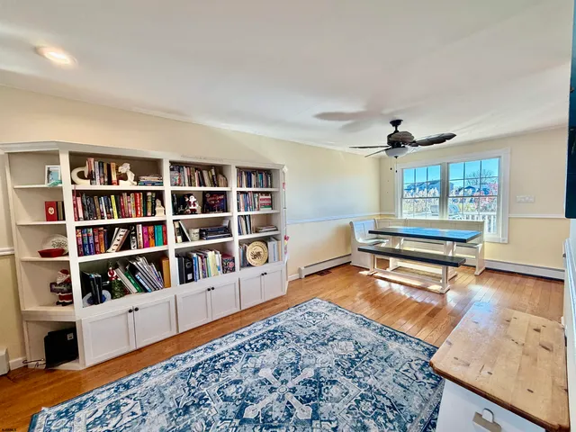 a room with lots of books and a large window
