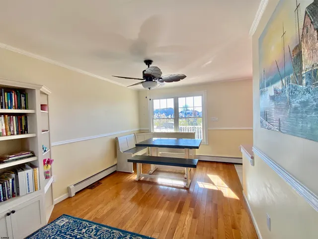 a living room with furniture and a book shelf