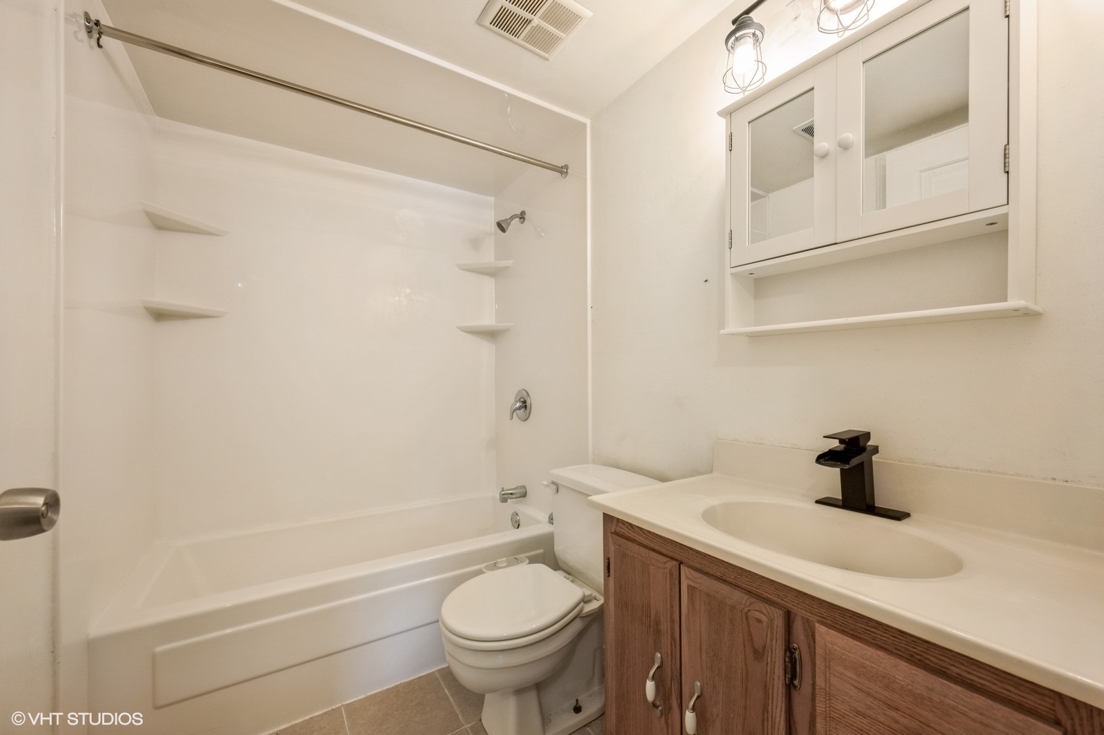3325 Kirchoff Road, Unit 3E Rolling Meadows, IL 60008 - Photo 8 of 10 a bathroom with a sink a toilet and shower