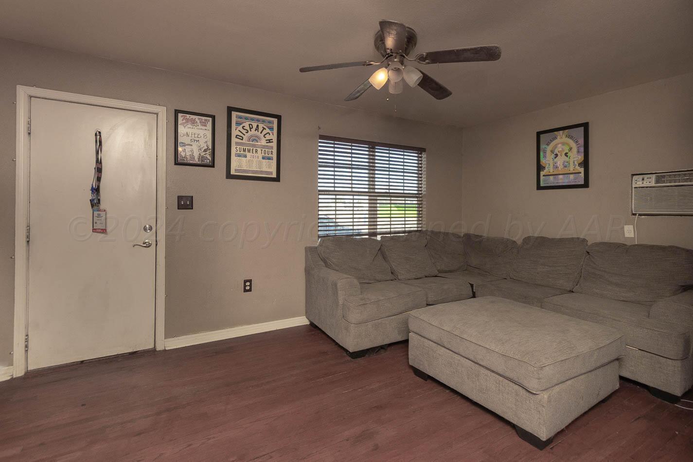 4101 South Washington Street Amarillo, TX 79110 - Photo 3 of 12 a living room with couches and a ceiling fan