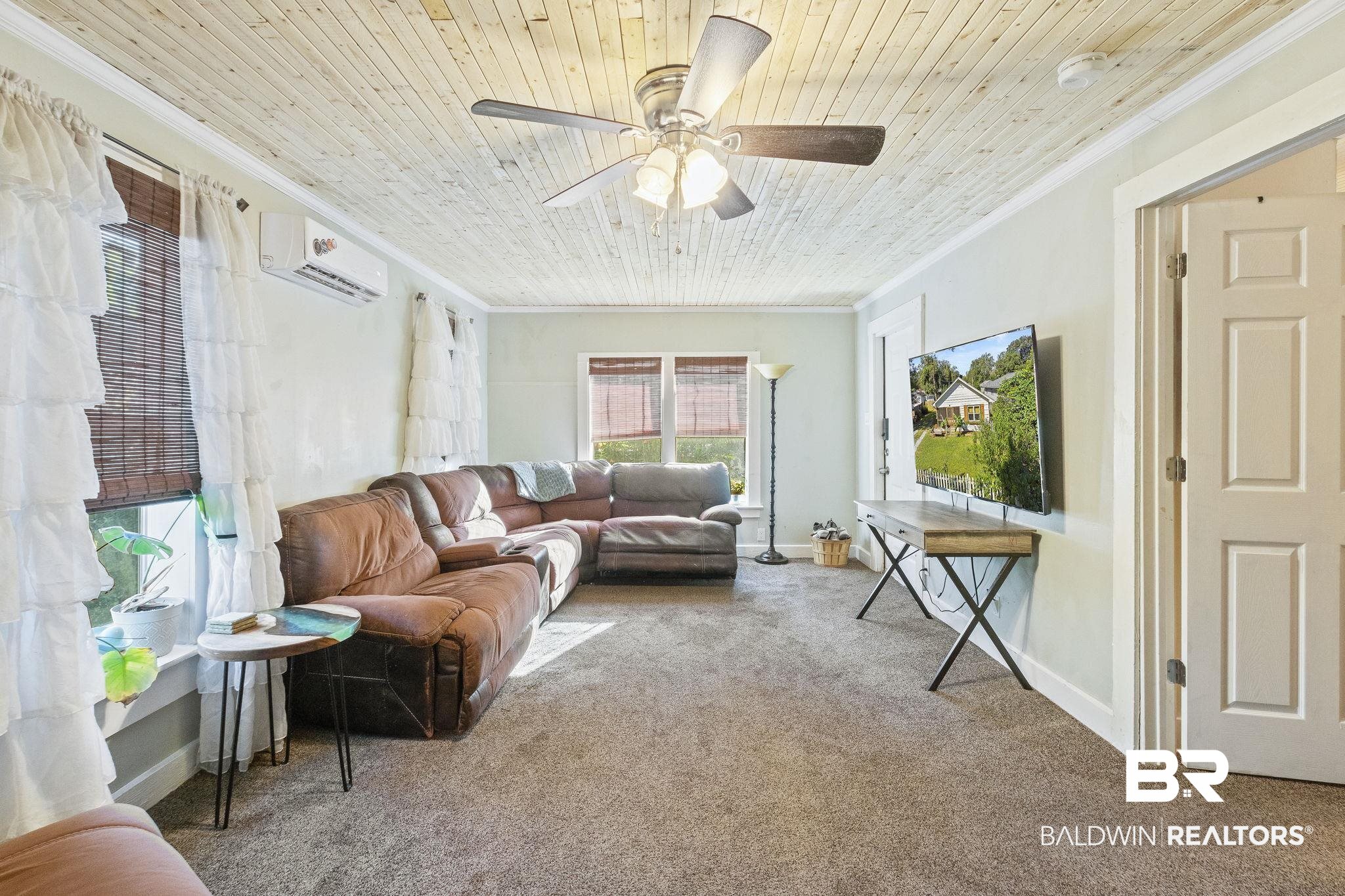 707 North Cedar Street Foley, AL 36535 - Photo 9 of 69 Sunroom / solarium featuring wood ceiling, an AC wall unit, and ceiling fan