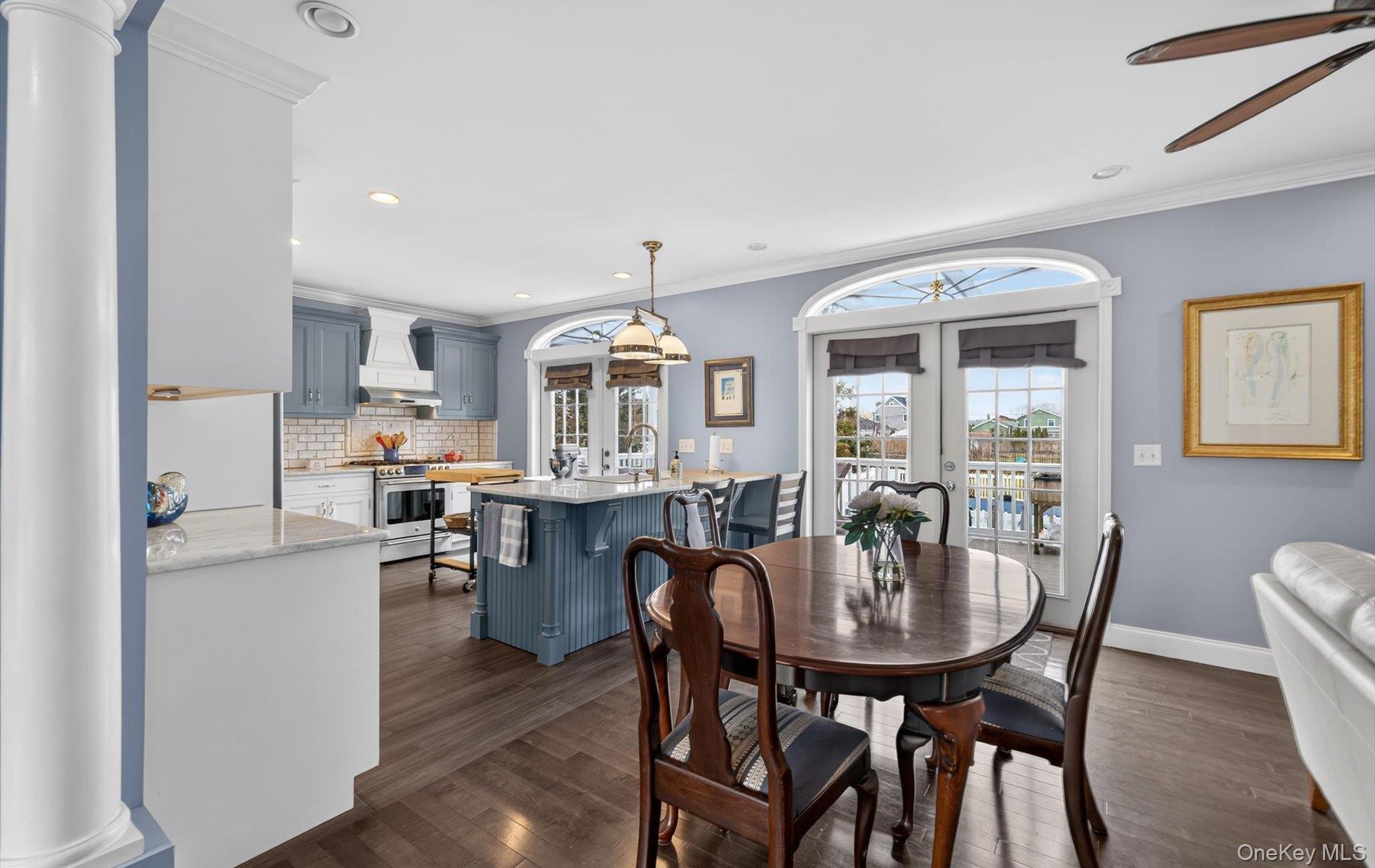 108 Awixa Avenue Bay Shore, NY 11706 - Photo 15 of 47 Dining area with french doors, ornamental molding, dark wood-style flooring, recessed lighting, and a ceiling fan