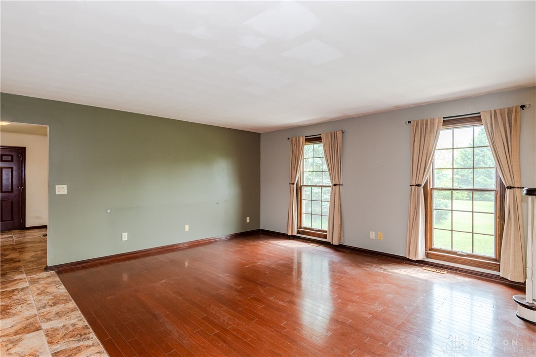 9981 Ridge Acres Lane Englewood, OH 45322 - Photo 8 of 73 This expansive living area features lustrous hardwood flooring and abundant natural light.