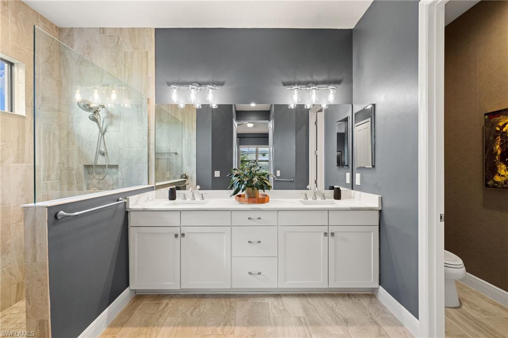 3967 Pegasus Way Naples, FL 34120 - Photo 15 of 50 a bathroom with a double vanity sink and a mirror