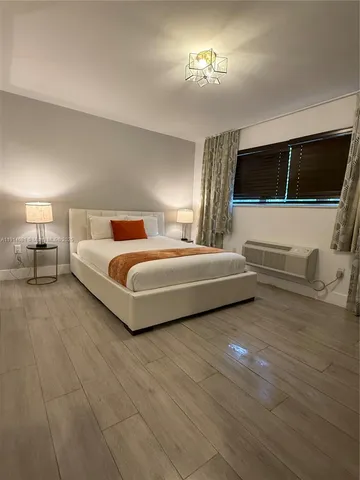 a bedroom with a bed and a view of en suite bathroom