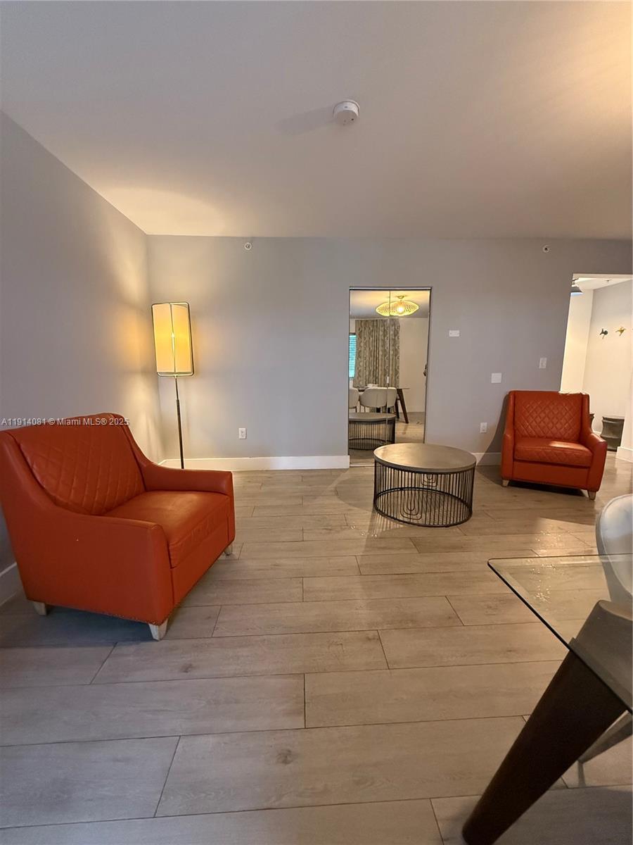 6755 Harding Avenue, Unit 3 Miami Beach, FL 33141 - Photo 6 of 7 a living room with furniture and a window