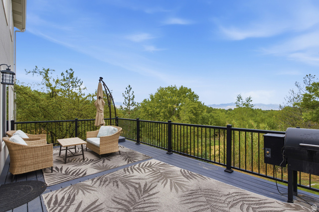 11882 Pond Ridge Drive Draper, UT 84020 - Photo 42 of 49 Expansive outdoor deck featuring dark gray composite decking and black metal railings