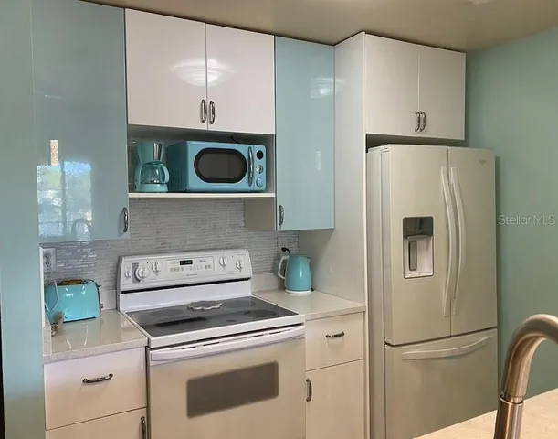 a kitchen with a stove and a refrigerator