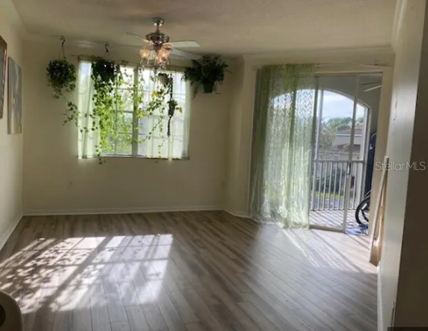en empty room with wooden floor and outdoor view