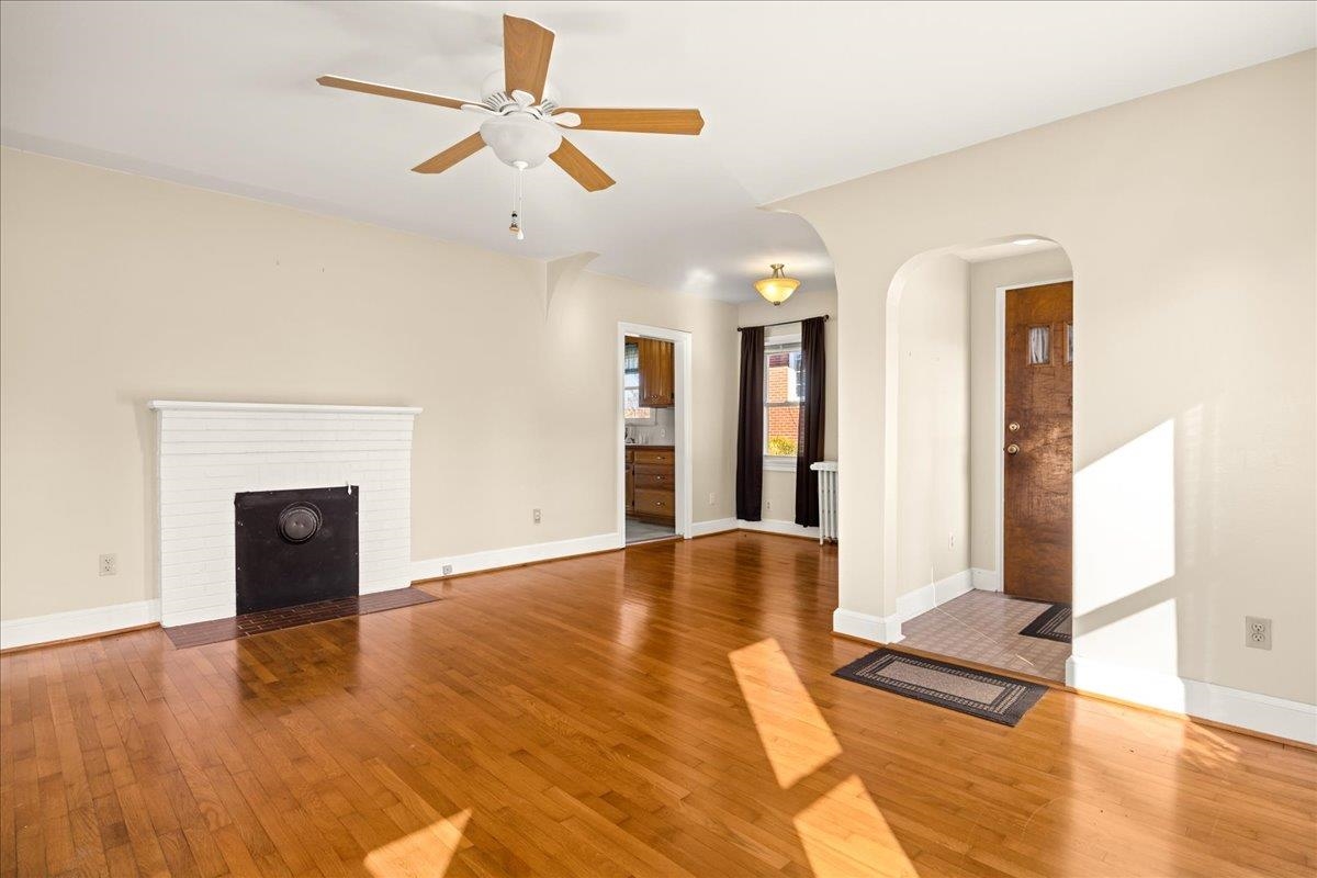 1439 Bluestone Street Harrisonburg, VA 22801 - Photo 10 of 34 a view of an empty room with wooden floor and a fireplace