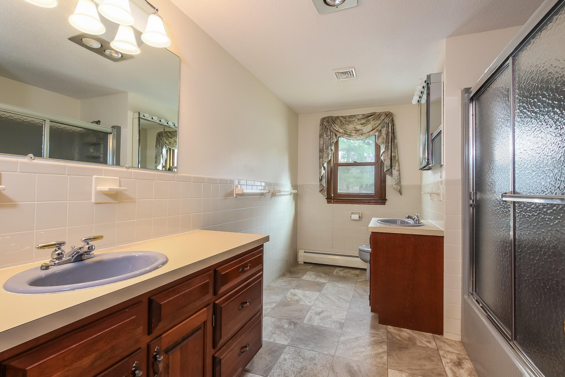 173 Rolling Hitch Road Centerville, MA 02632 - Photo 17 of 22 a bathroom with a sink and a mirror