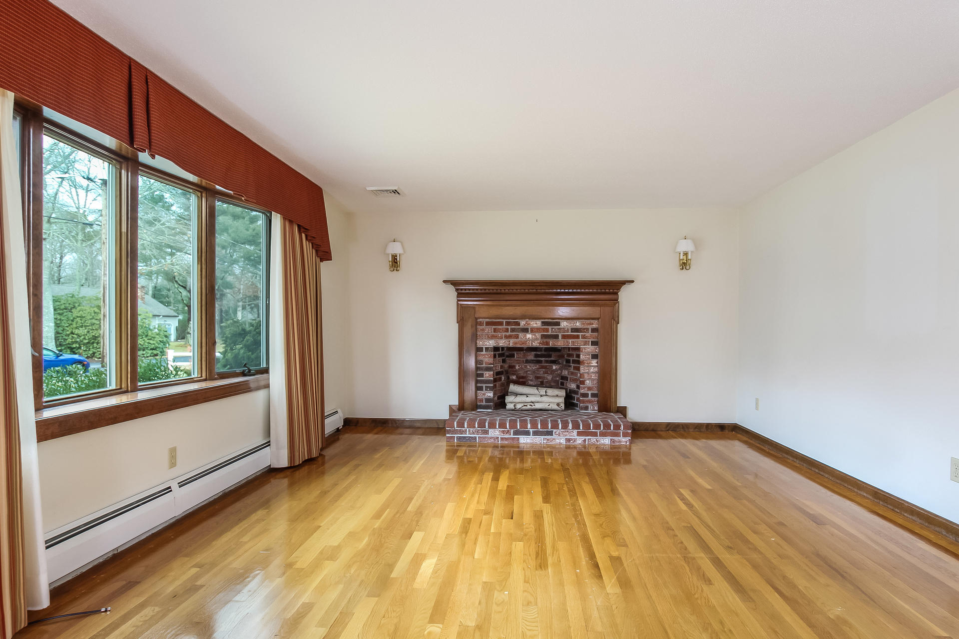 173 Rolling Hitch Road Centerville, MA 02632 - Photo 4 of 22 a view of empty room with wooden floor and fireplace