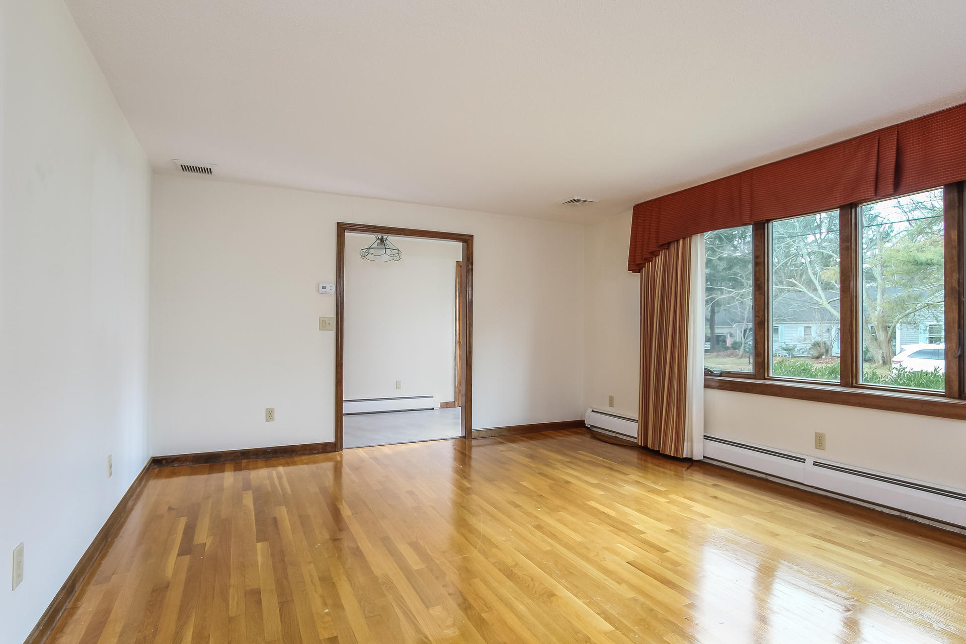 173 Rolling Hitch Road Centerville, MA 02632 - Photo 6 of 22 a view of an empty room with wooden floor and a window