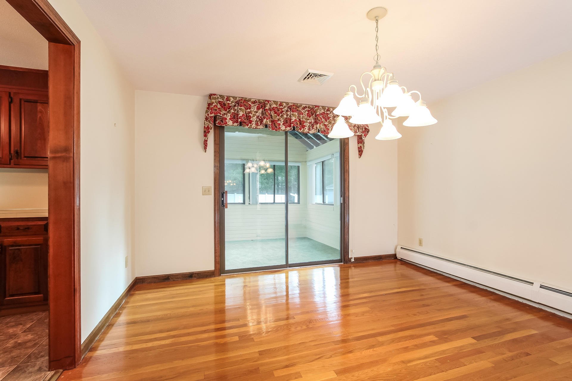 173 Rolling Hitch Road Centerville, MA 02632 - Photo 8 of 22 a view of a room with wooden floor and chandelier
