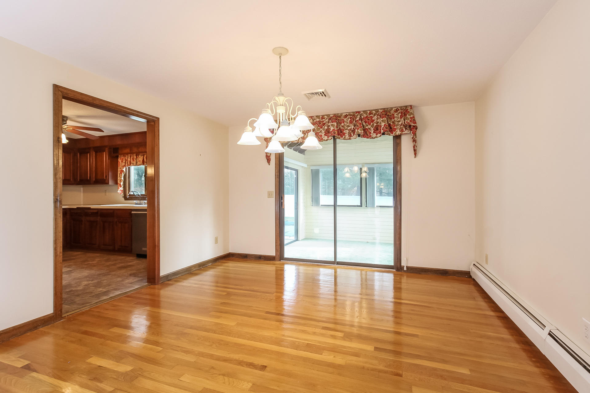 173 Rolling Hitch Road Centerville, MA 02632 - Photo 9 of 22 a view of a room with wooden floor and kitchen view