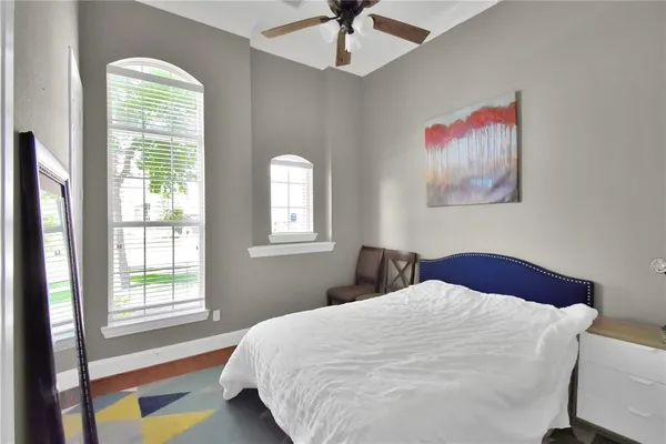 a bedroom with a bed and a chandelier