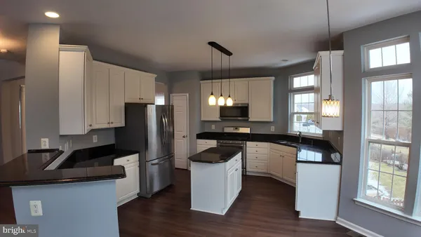 a kitchen with a refrigerator and a sink