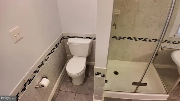 a white toilet sitting next to a bathroom sink