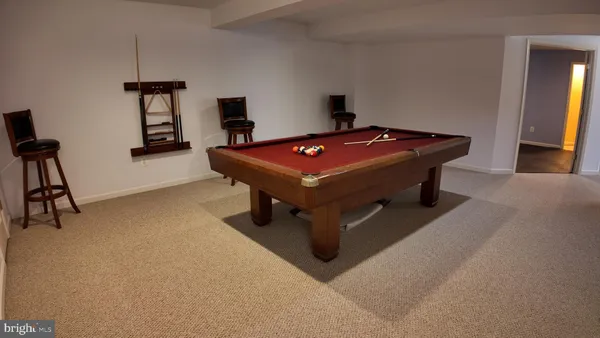 a room with pool table and windows